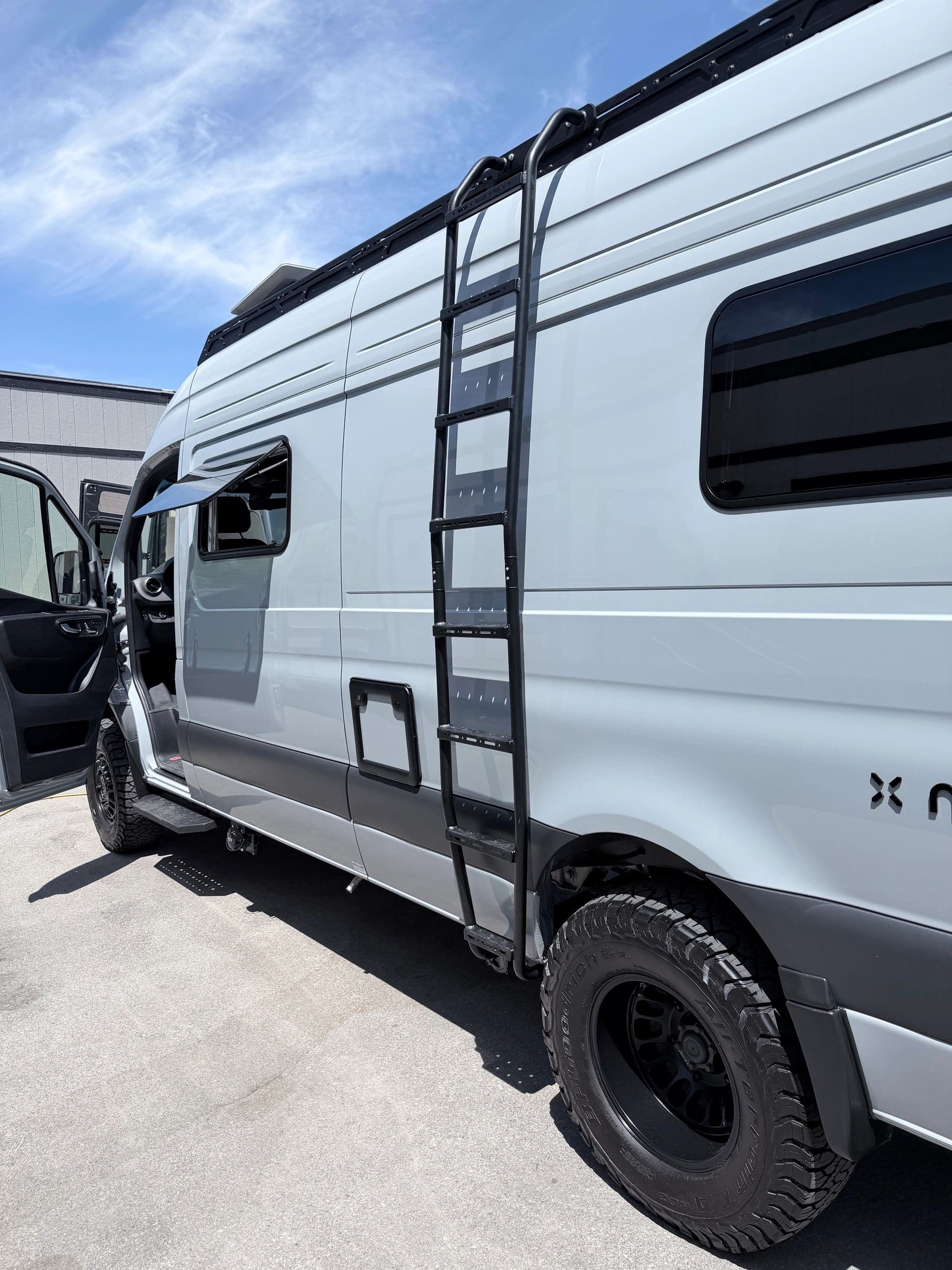 Nellie, a light gray 2026 Noovo Next AWD, parked in bright daylight